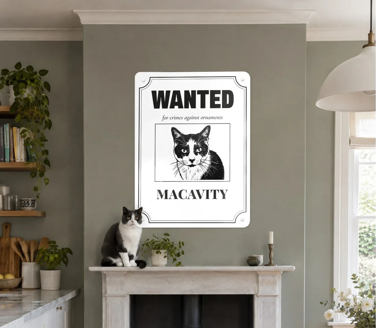 A Wanted poster pet portrait board of a cat called Macavity above a fireplace, with the cat sitting on the mantelpiece