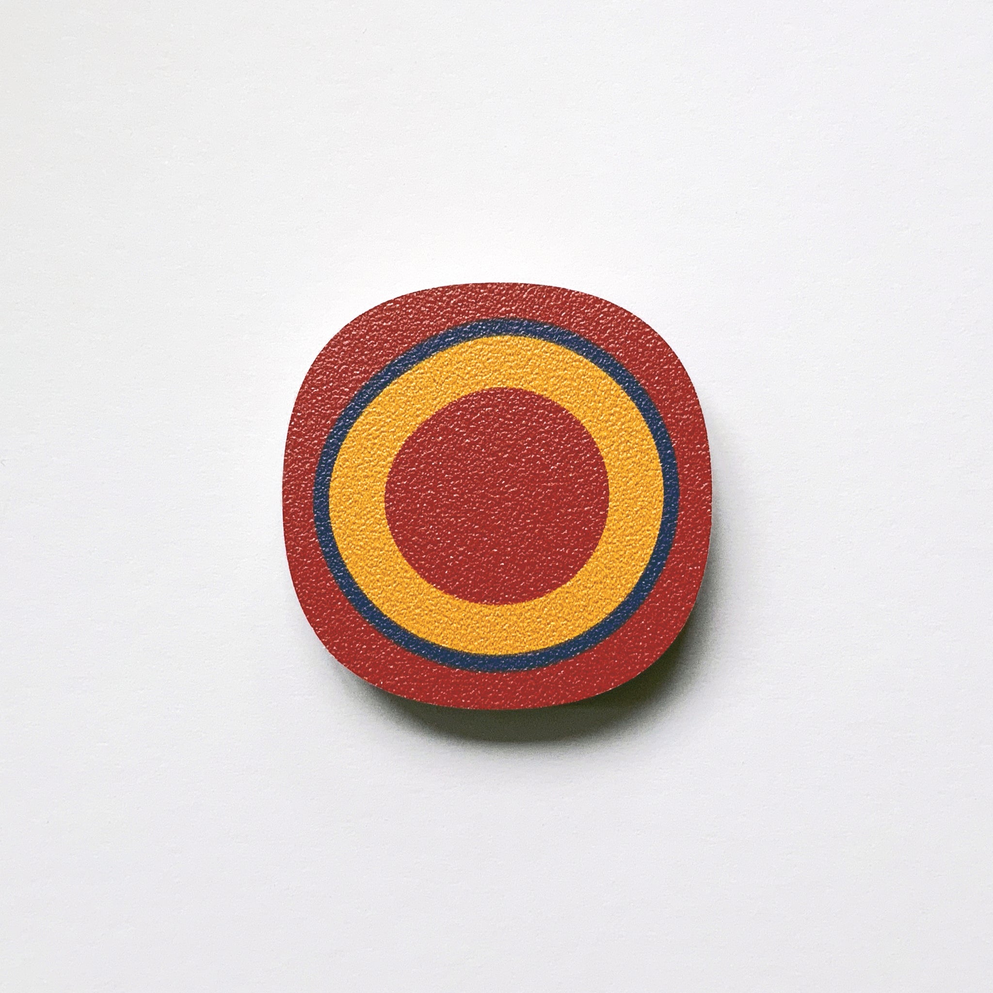 A red circle millefiori design plywood fridge magnet by Beyond the Fridge