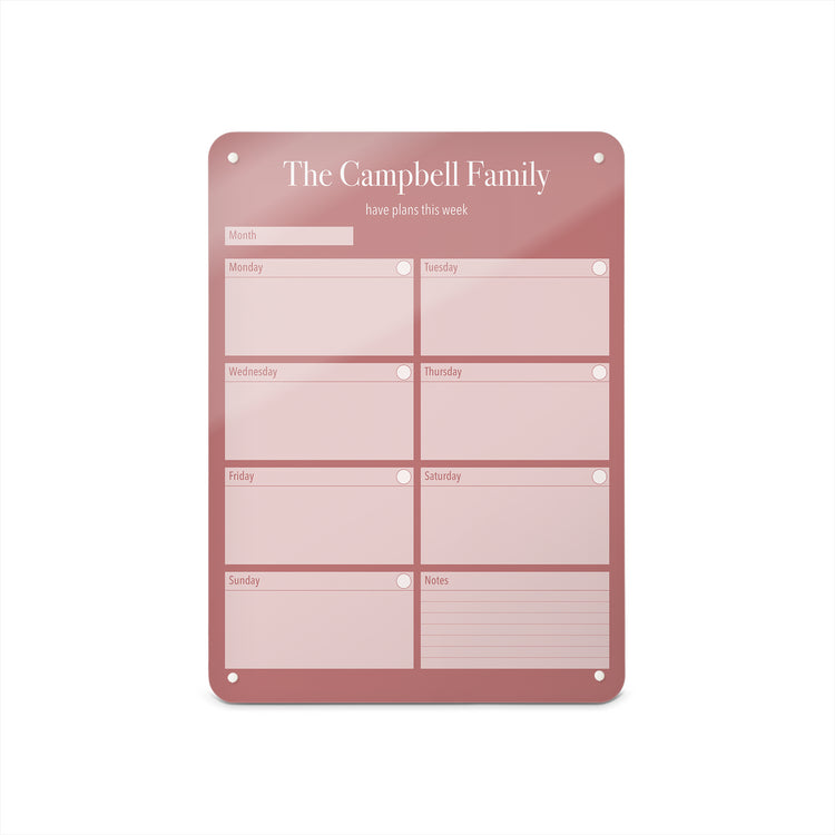 A medium magnetic notice board by Beyond the Fridge with a weekly planner design to personalise  in a pink colour and portrait format 