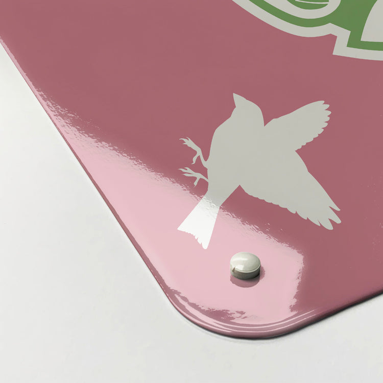 The corner detail of a black birds in a tree design magnetic board to show it’s high gloss surface