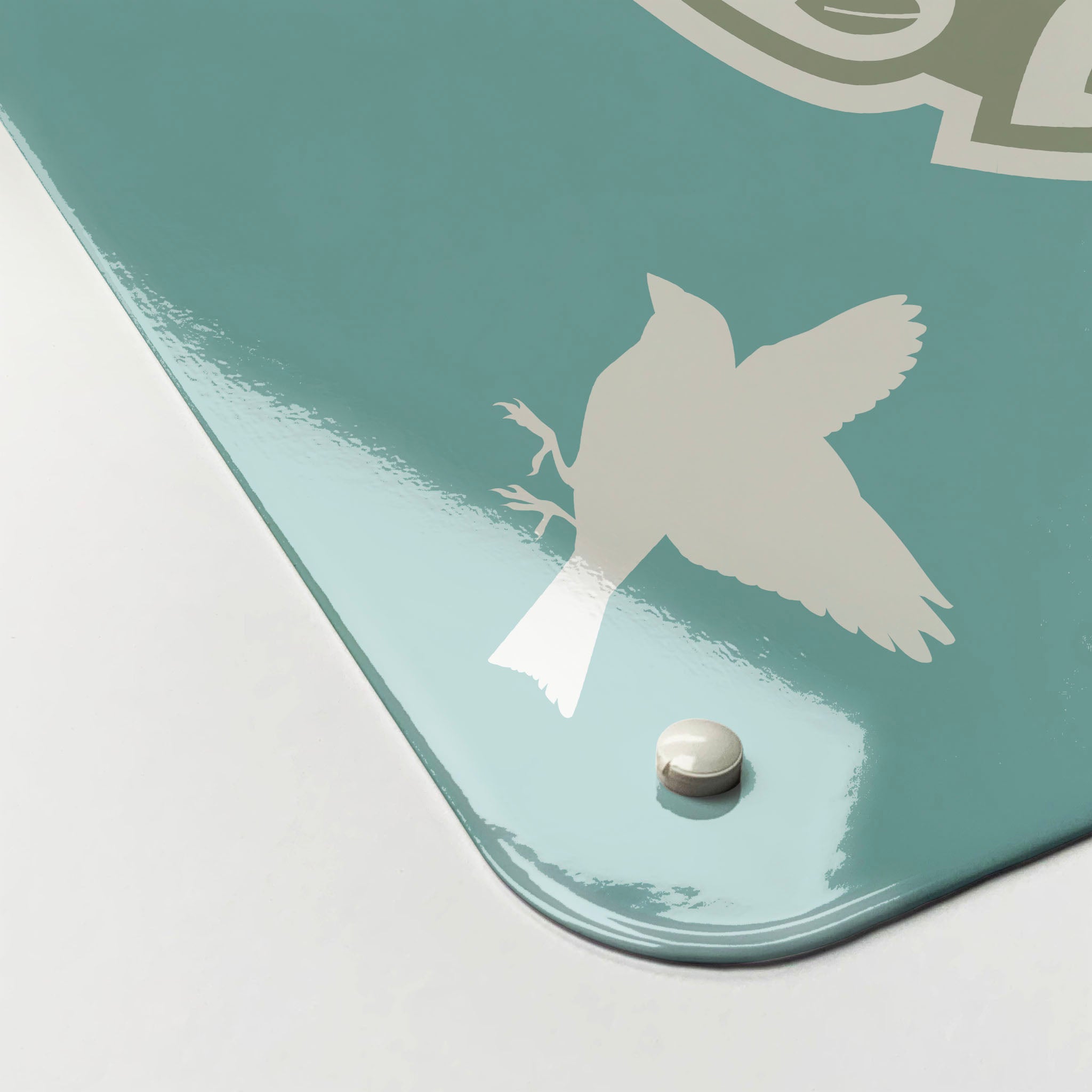 The corner detail of a blue birds in a tree design magnetic board to show it’s high gloss surface