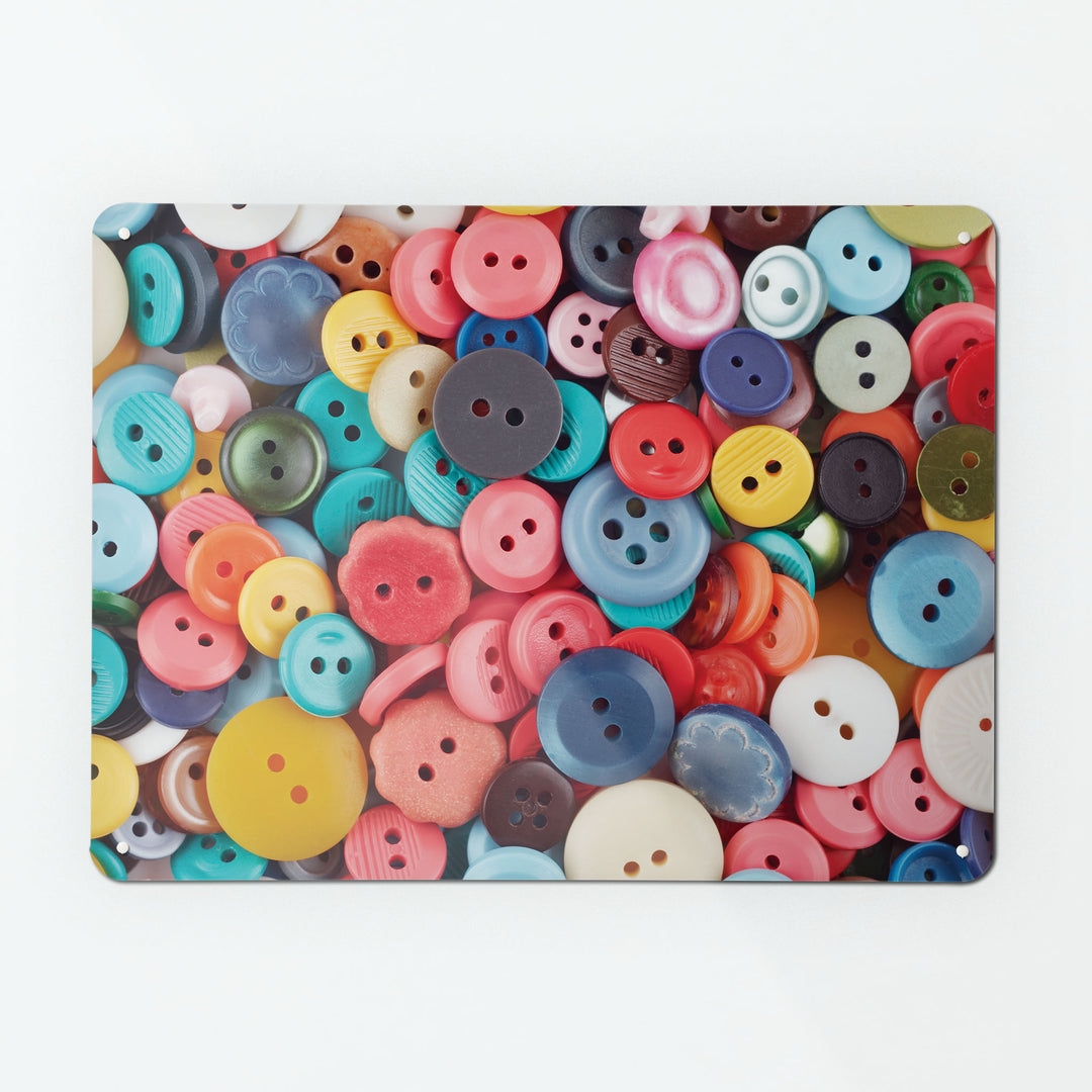 A large magnetic notice board by Beyond the Fridge with an image of colourful scattered buttons