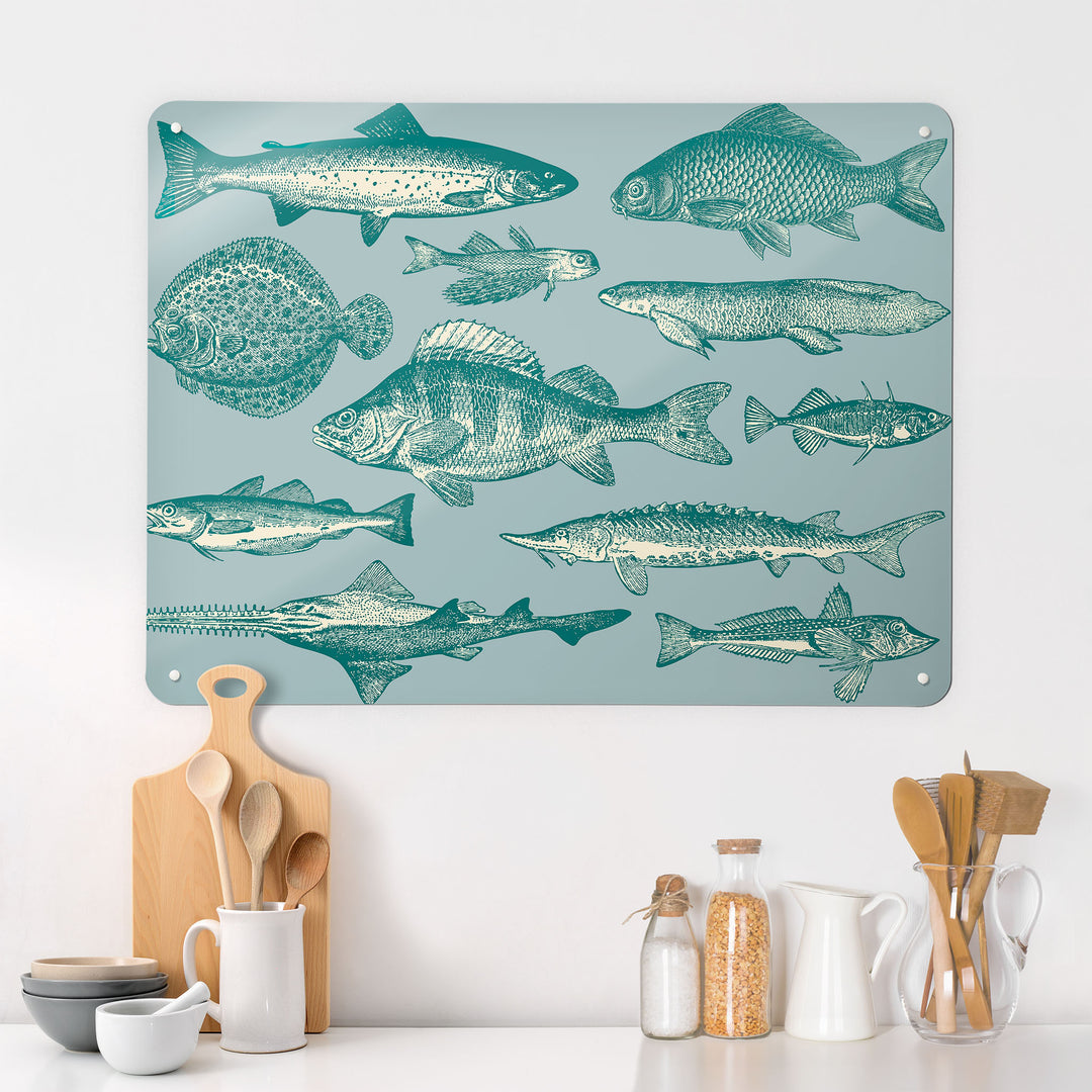 A kitchen  interior with a magnetic metal wall art panel showing a shoal of fish illustration in blue