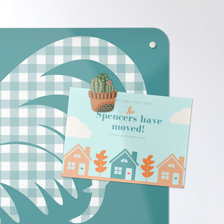 A postcard on a gingham cockerel magnetic board or metal wall art panel