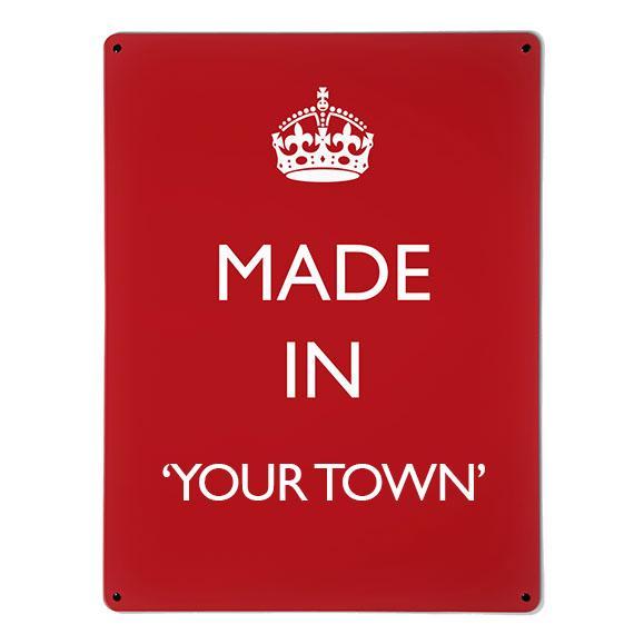 A large magnetic notice board by Beyond the Fridge with a made in your town typographic design to personalise in white lettering on red