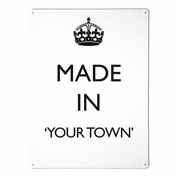 A large magnetic notice board by Beyond the Fridge with a made in your town typographic design to personalise in black lettering on white