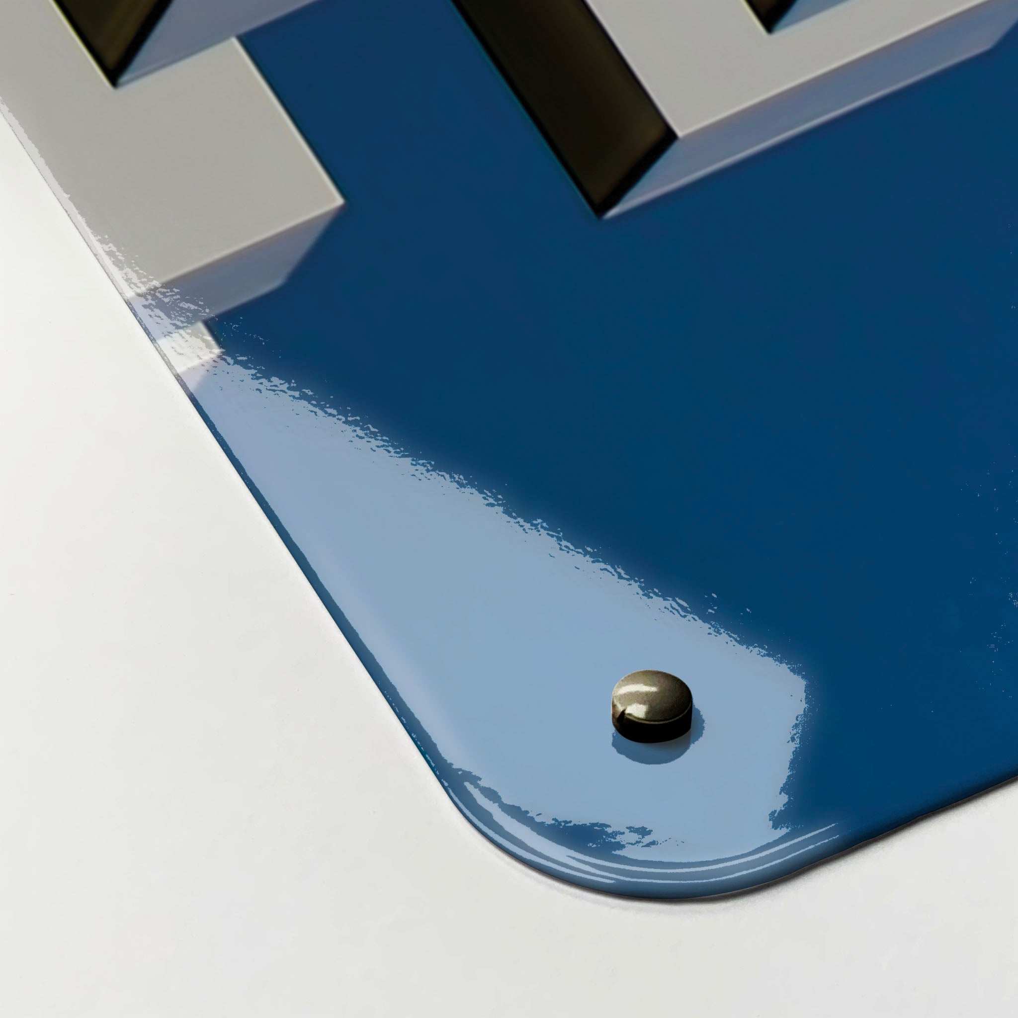 The corner detail of a brutalist balconies photographic magnetic board to show it’s high gloss surface