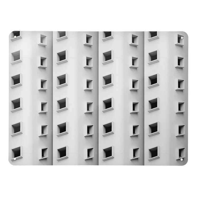 A large magnetic notice board by Beyond the Fridge with a black and white photograph  of a building with lots of windows