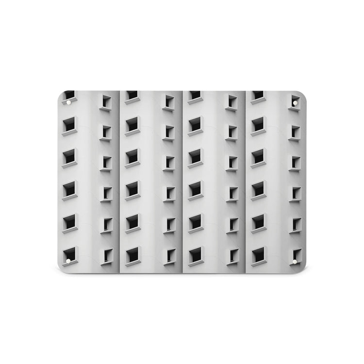 A medium magnetic notice board by Beyond the Fridge with a black and white photograph  of a building with a pattern of windows