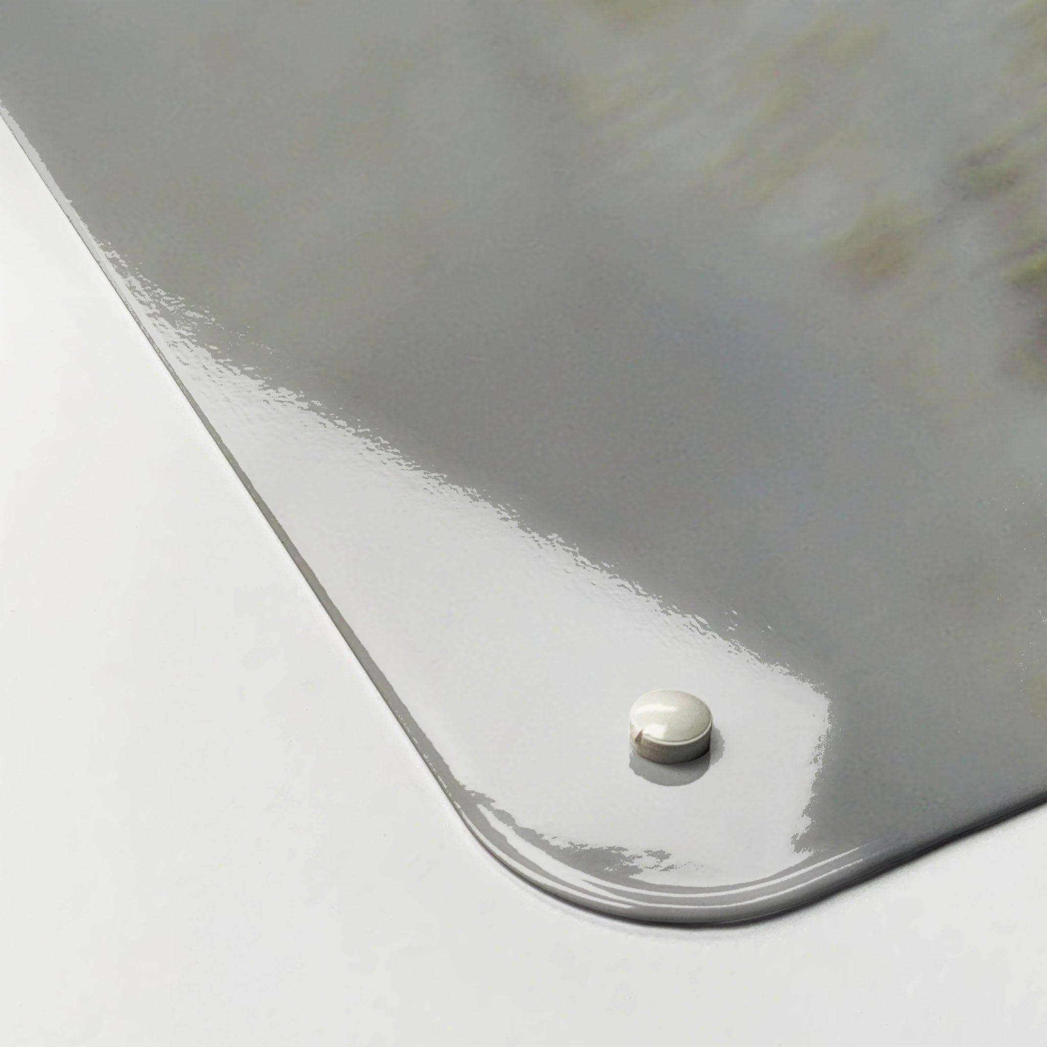 The corner detail of a white peacock photographic magnetic board to show it’s high gloss surface