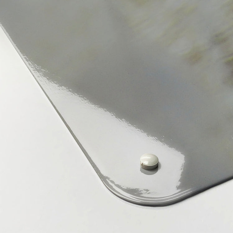 The corner detail of a white peacock photographic magnetic board to show it’s high gloss surface