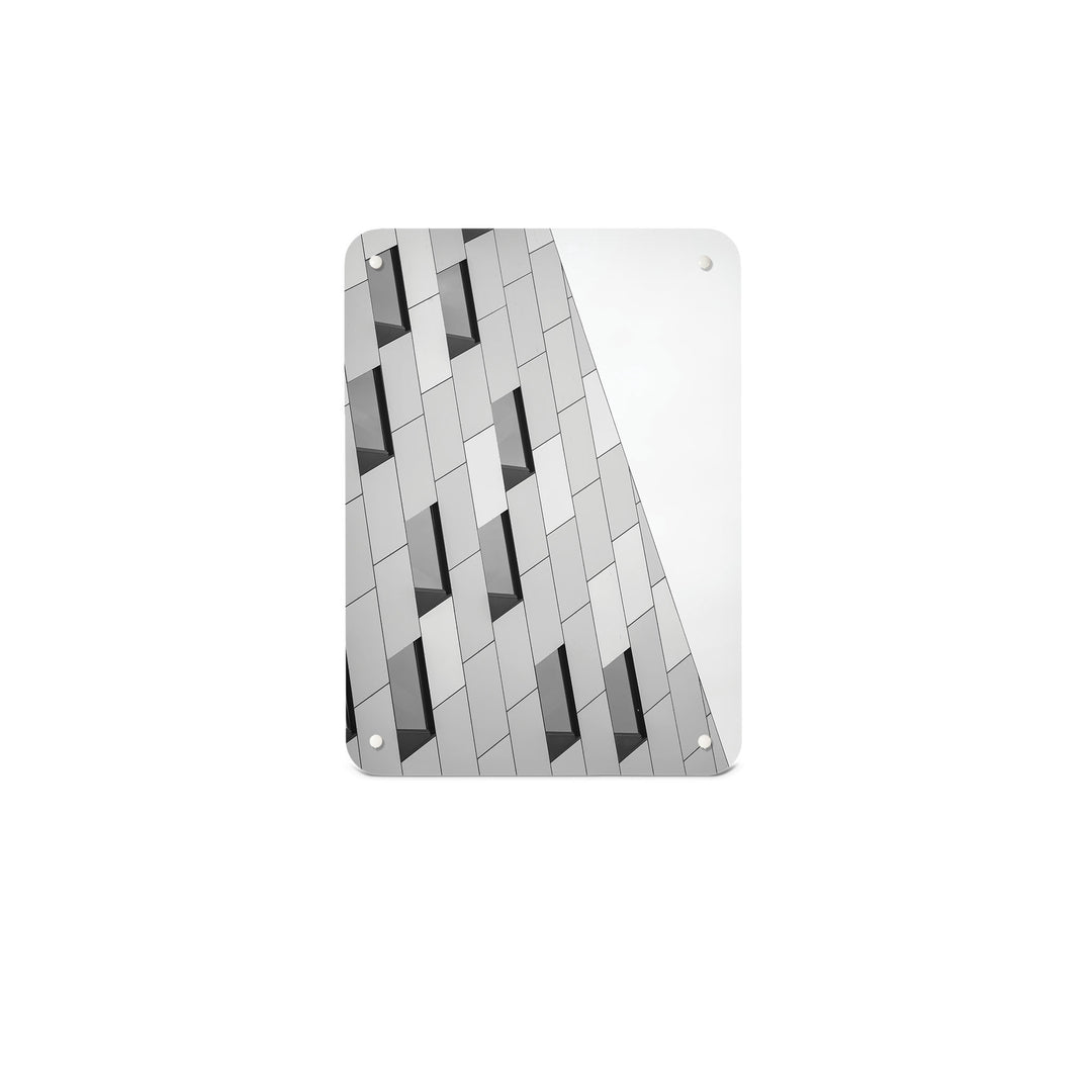A small magnetic notice board by Beyond the Fridge with an image of an abstract building and windows in black and white