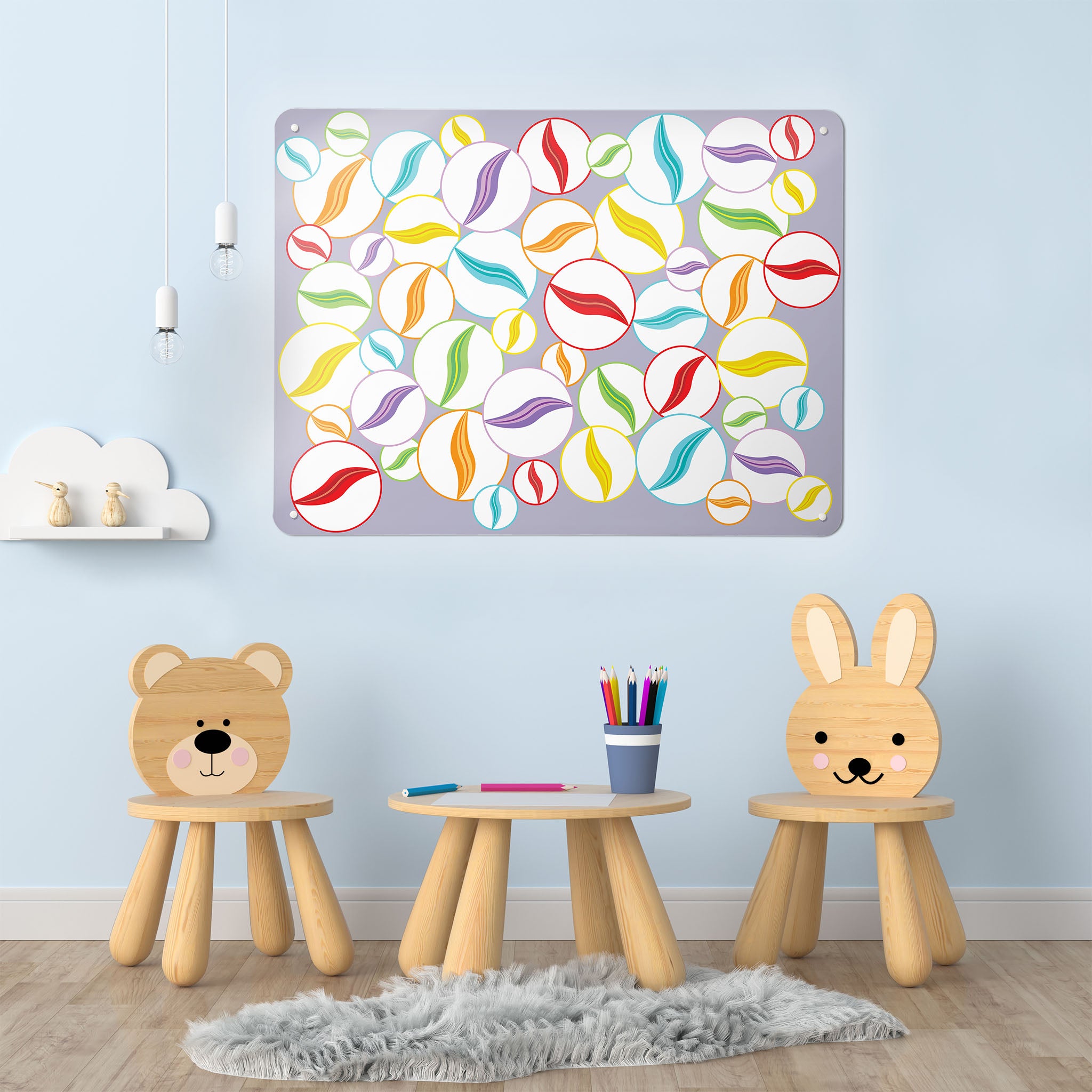 A playroom interior with a magnetic metal wall art panel showing multi coloured marbles on a mauve background design