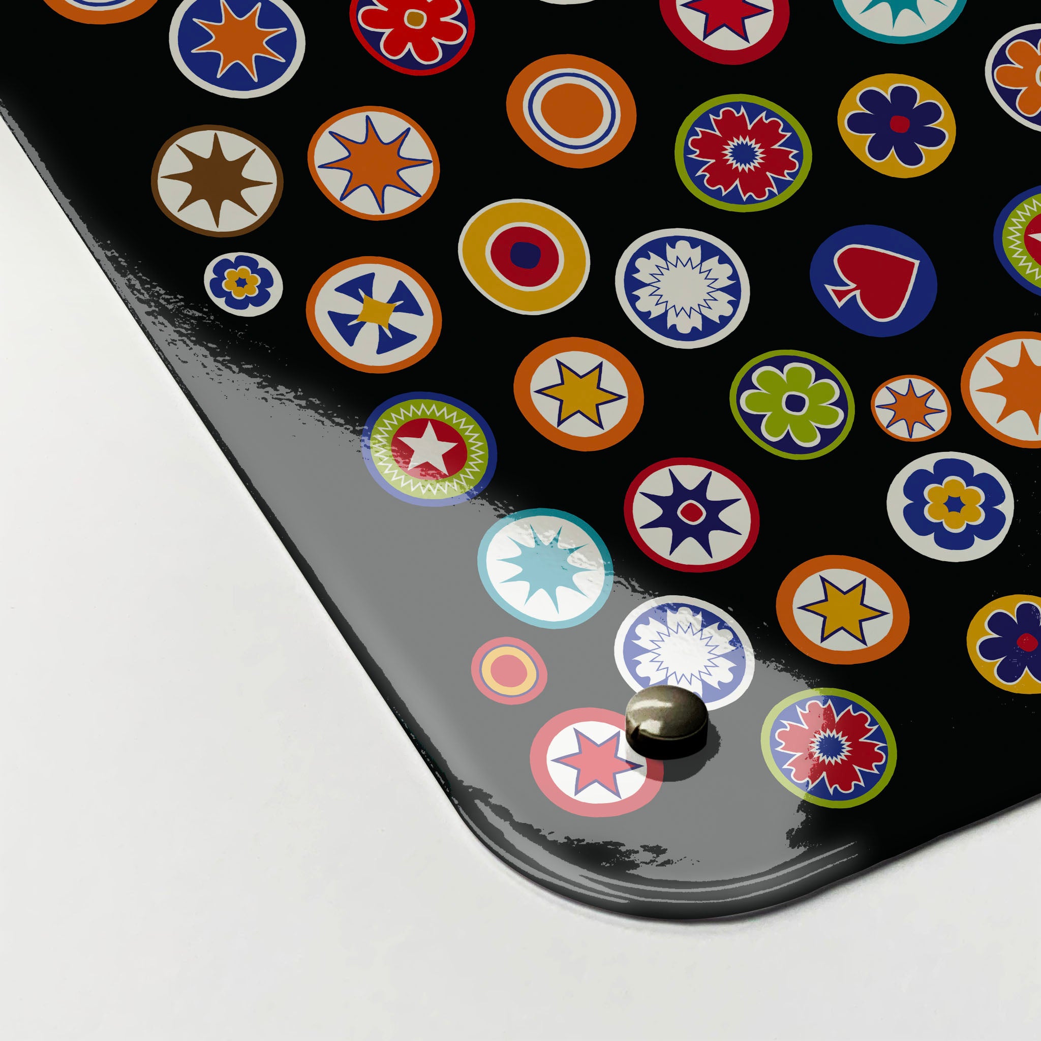The corner detail of a millefiori on black design magnetic board to show it’s high gloss surface