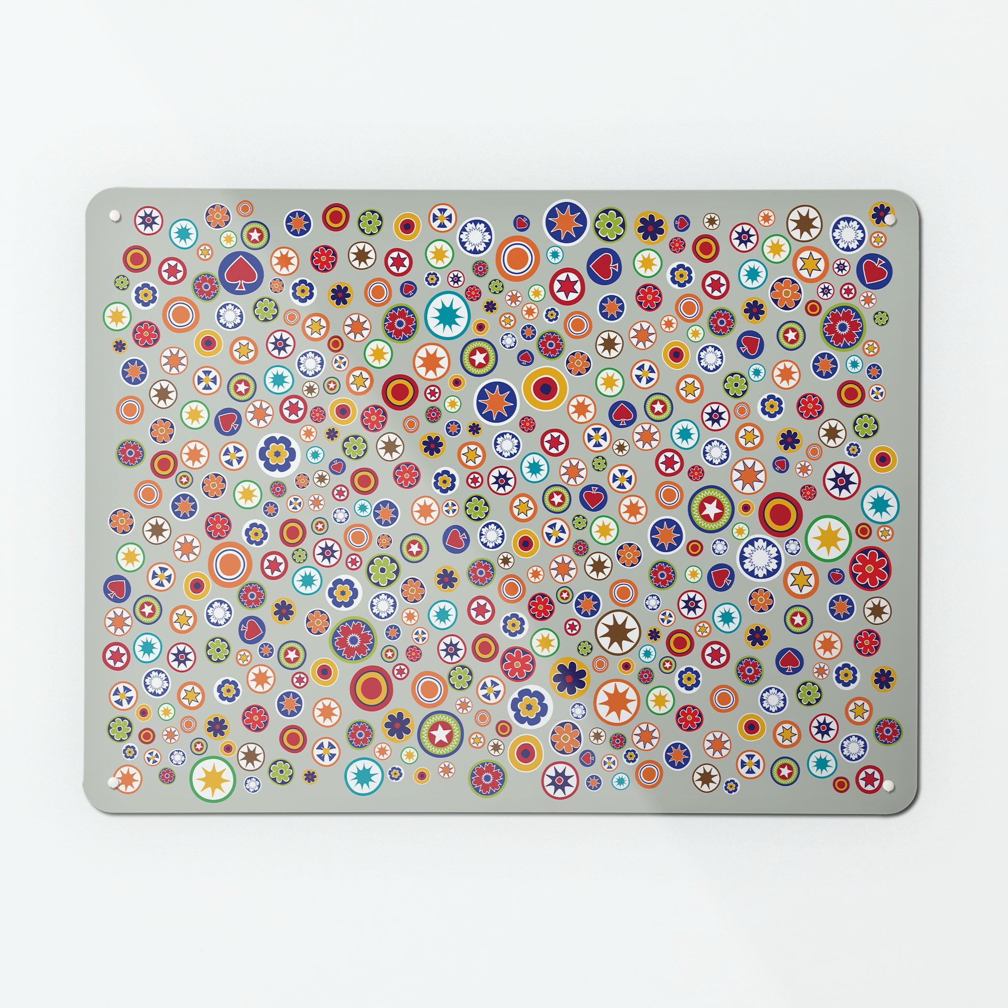 A large magnetic notice board by Beyond the Fridge with a scattered  millefiori  glass beads design on a grey background