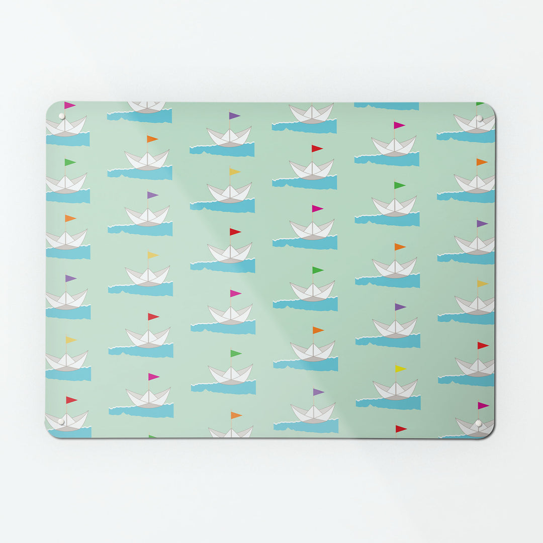 A large magnetic notice board by Beyond the Fridge with a paper boats design with coloured flags on a pale green background