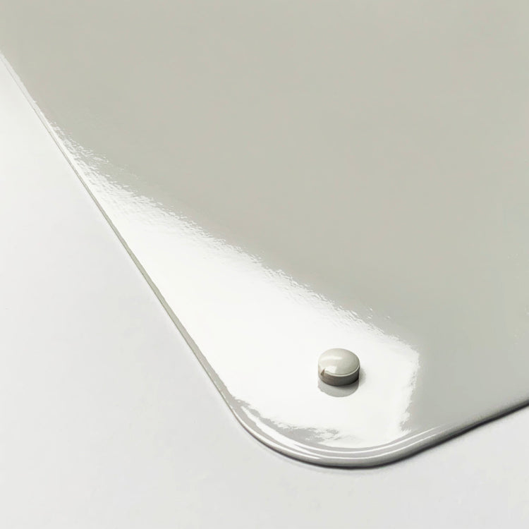 The corner detail of a plain white magnetic board to show it’s high gloss surface