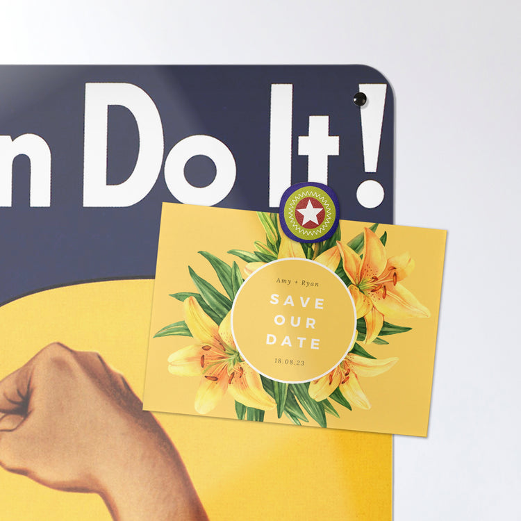 A postcard on a Rosie the Riveter magnetic board or metal wall art panel