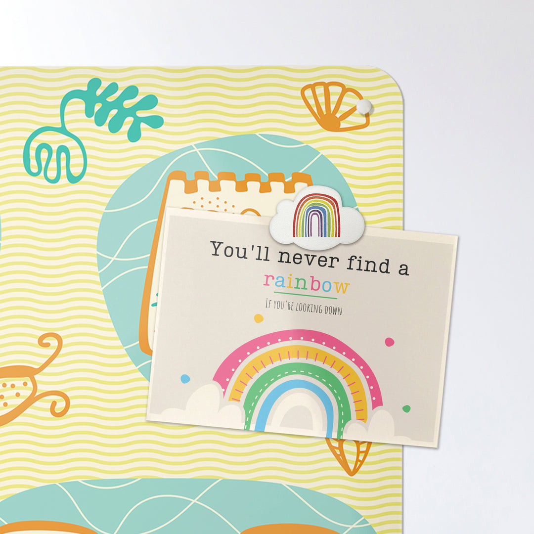 A postcard on a sandcastles design magnetic board or metal wall art panel