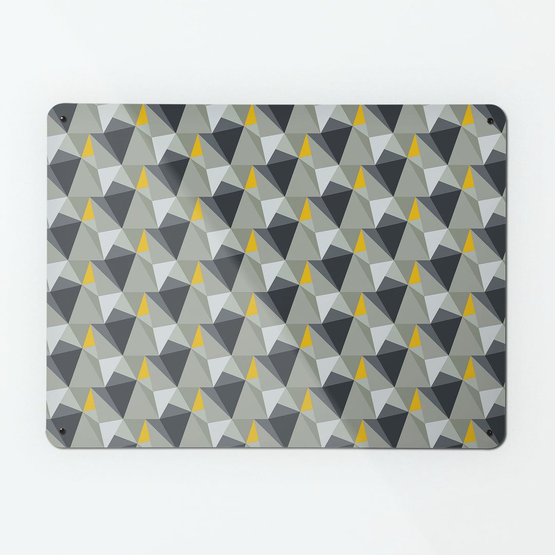 A large magnetic notice board by Beyond the Fridge with a shards geometric design in grey and yellow colours