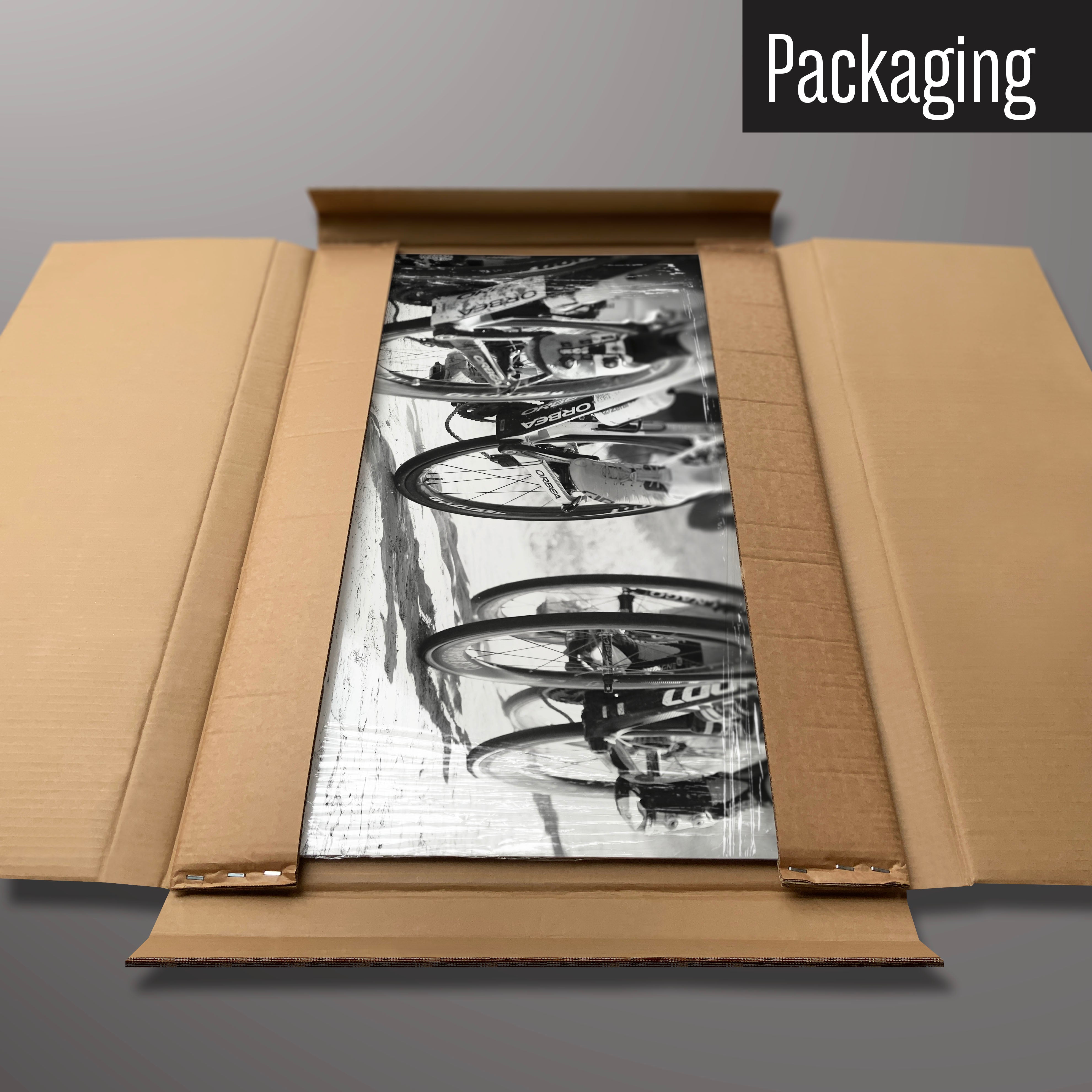 A black and white cyclists photographic magnetic board in it’s cardboard packaging