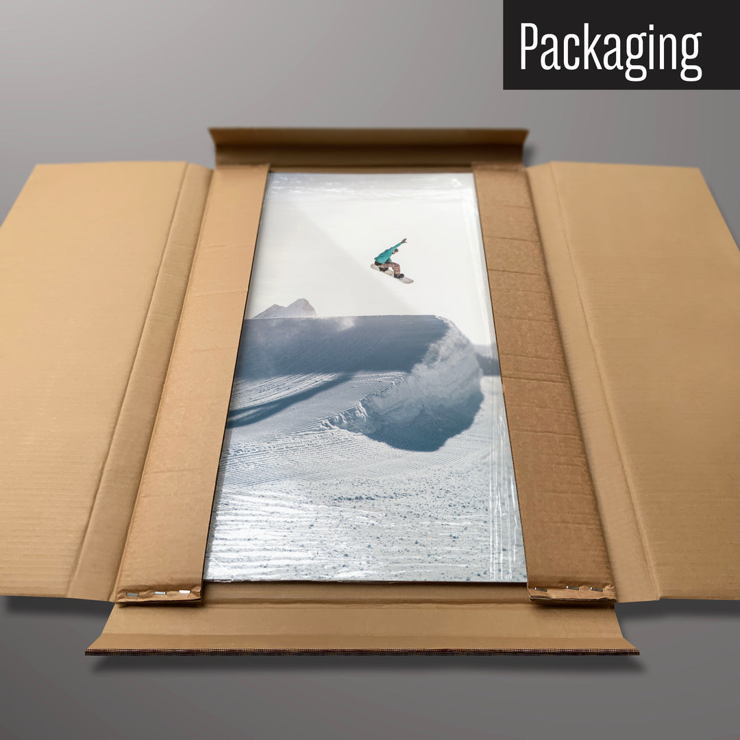 A snowboarding photographic magnetic board in it’s cardboard packaging