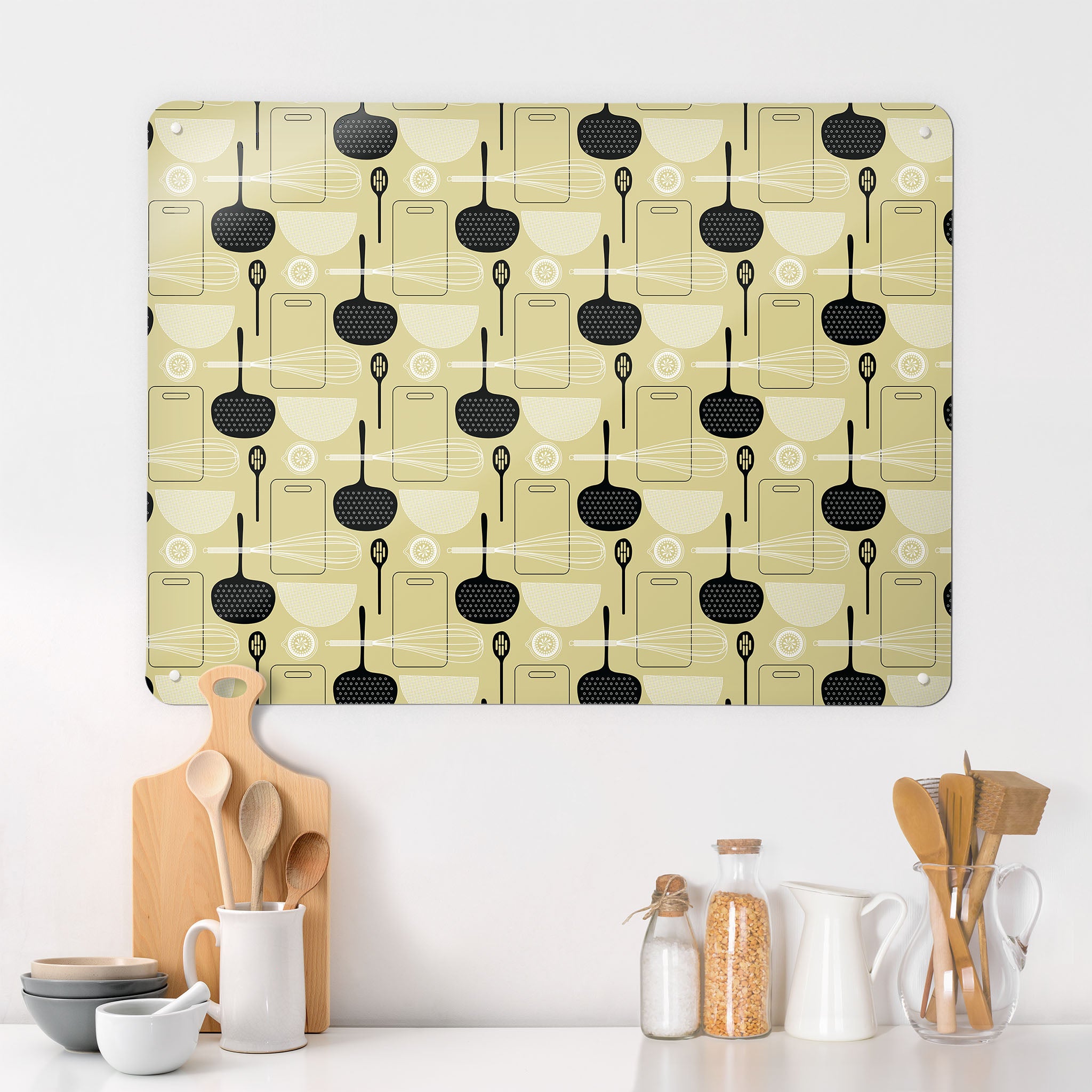 A kitchen interior with a magnetic metal wall art panel showing a light olive utensils repeat pattern design