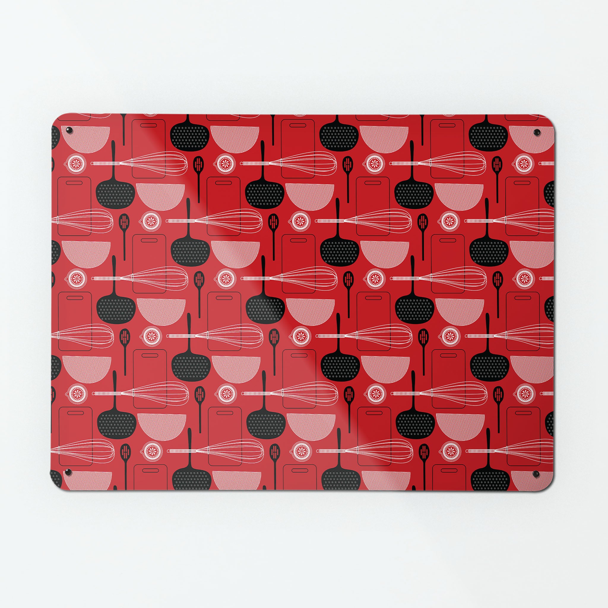 A large magnetic notice board by Beyond the Fridge with a utensils repeat pattern design in red colour way