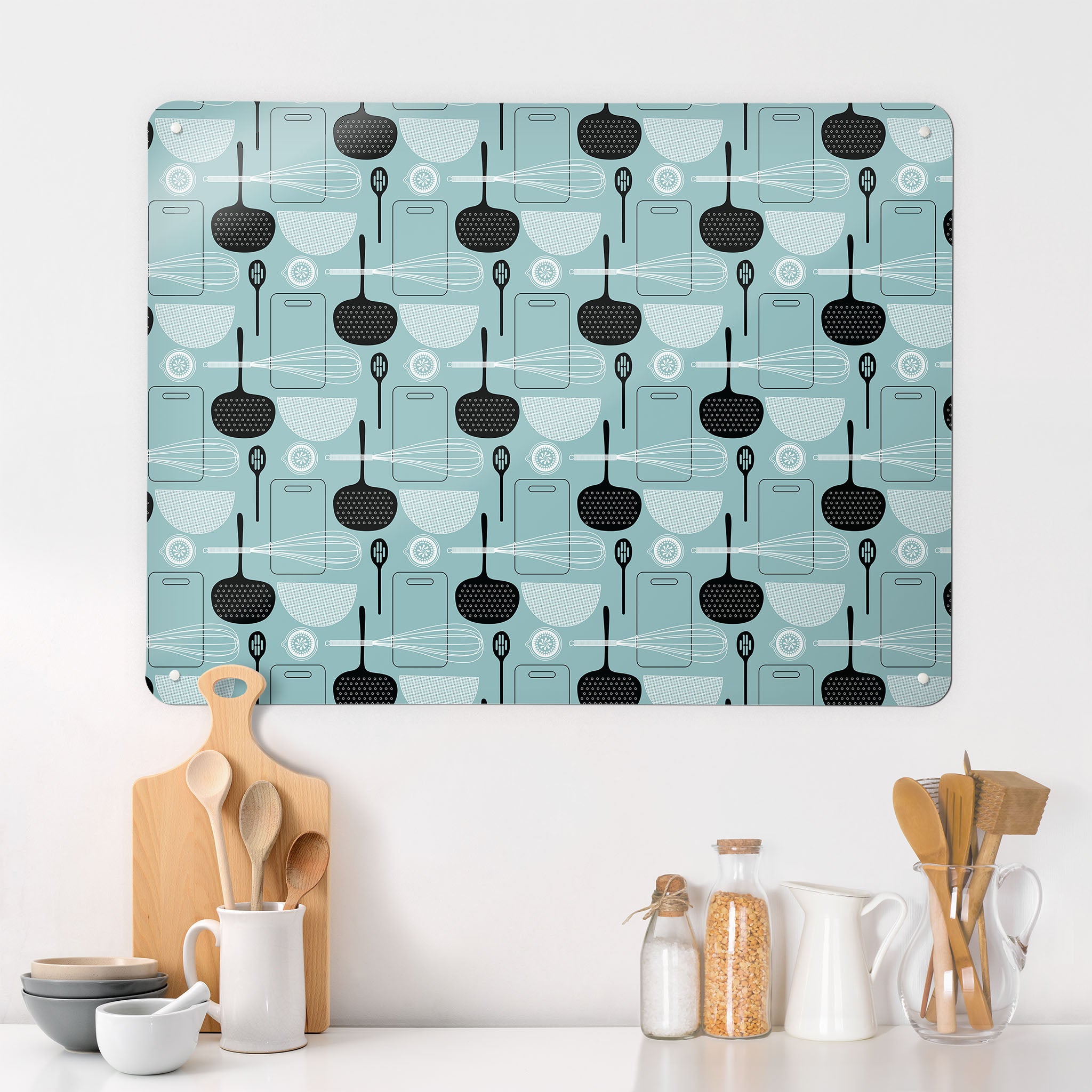 A kitchen interior with a magnetic metal wall art panel showing a blue utensils repeat pattern design