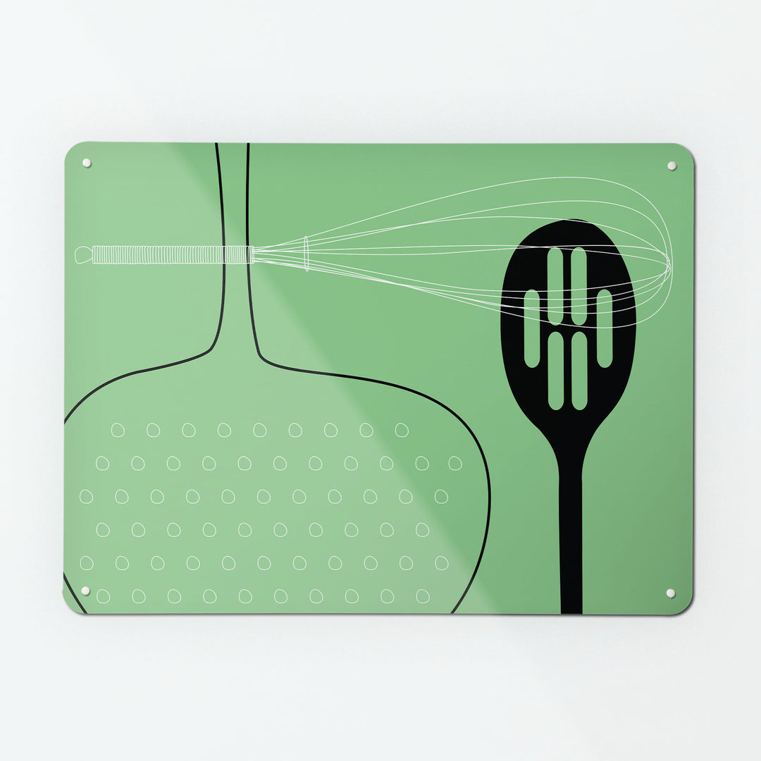 A large magnetic notice board by Beyond the Fridge with a utensils design in green colour way