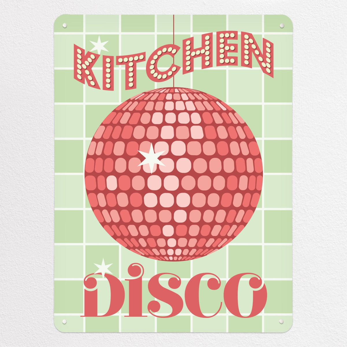 A glitter ball illustration in pink colour with the words 'Kitchen Disco' on a green tiled background on a magnetic board
