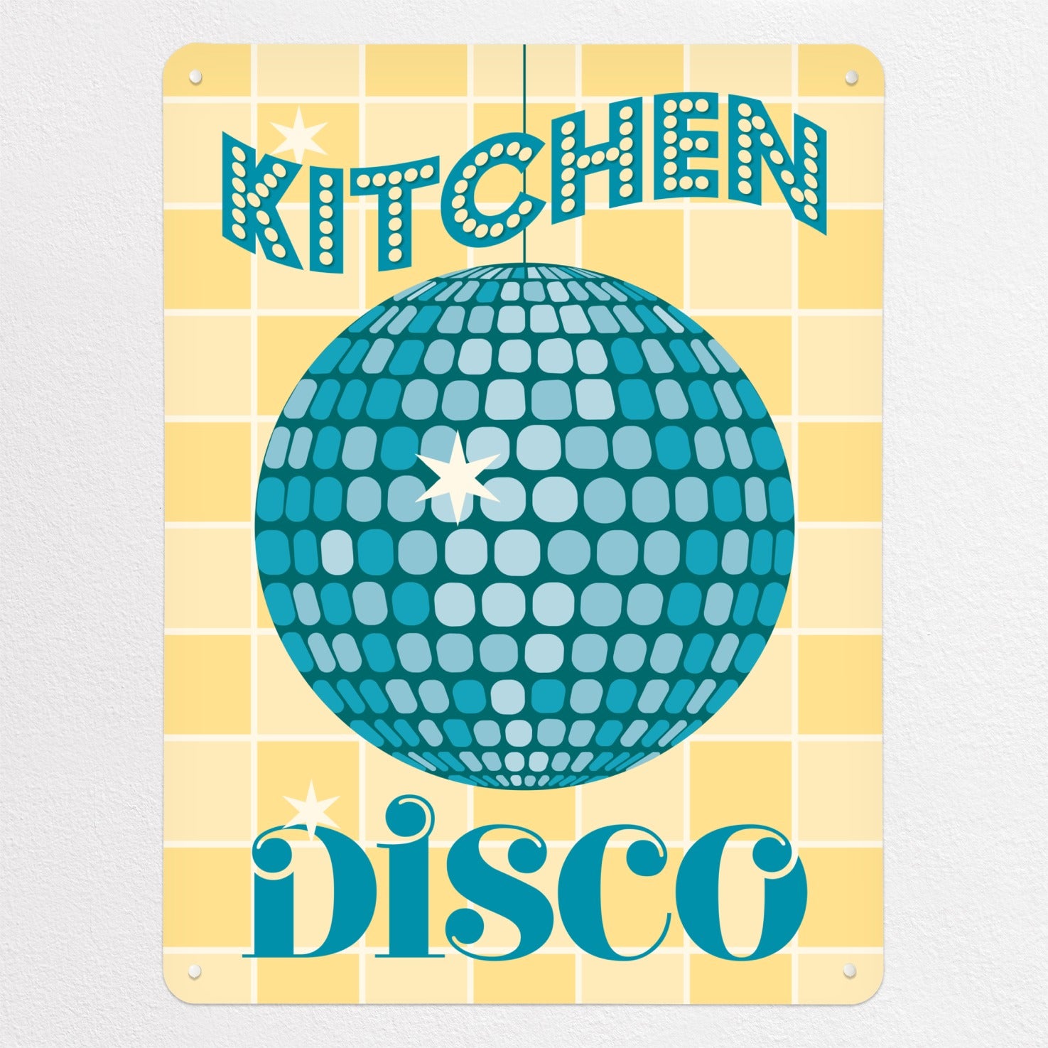 A glitter ball illustration in teal colour with the words 'Kitchen Disco' on a yellow tiled background on a magnetic board