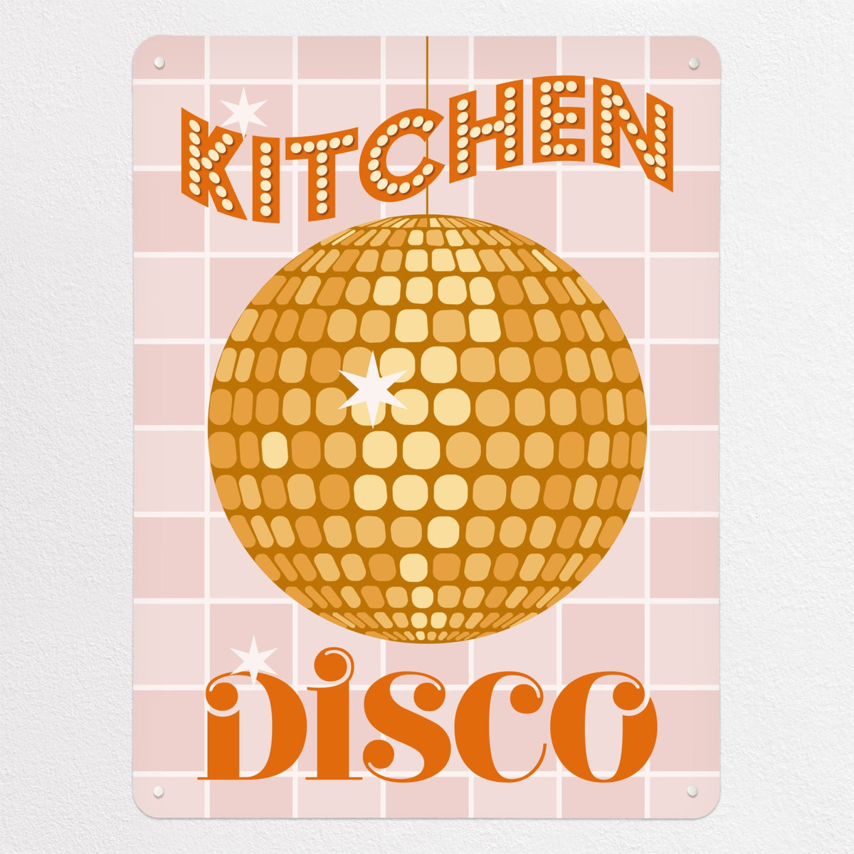 A glitter ball illustration in yellow colour with the words 'Kitchen Disco' on a pink tiled background on a magnetic board