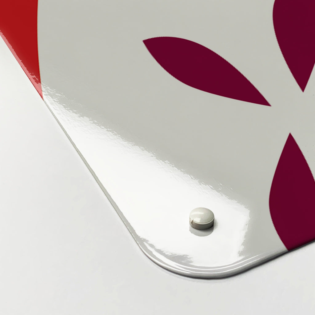 Close-up of the corner of the Apples magnetic notice board in Red Apples, showing the gloss finish and a screw cap