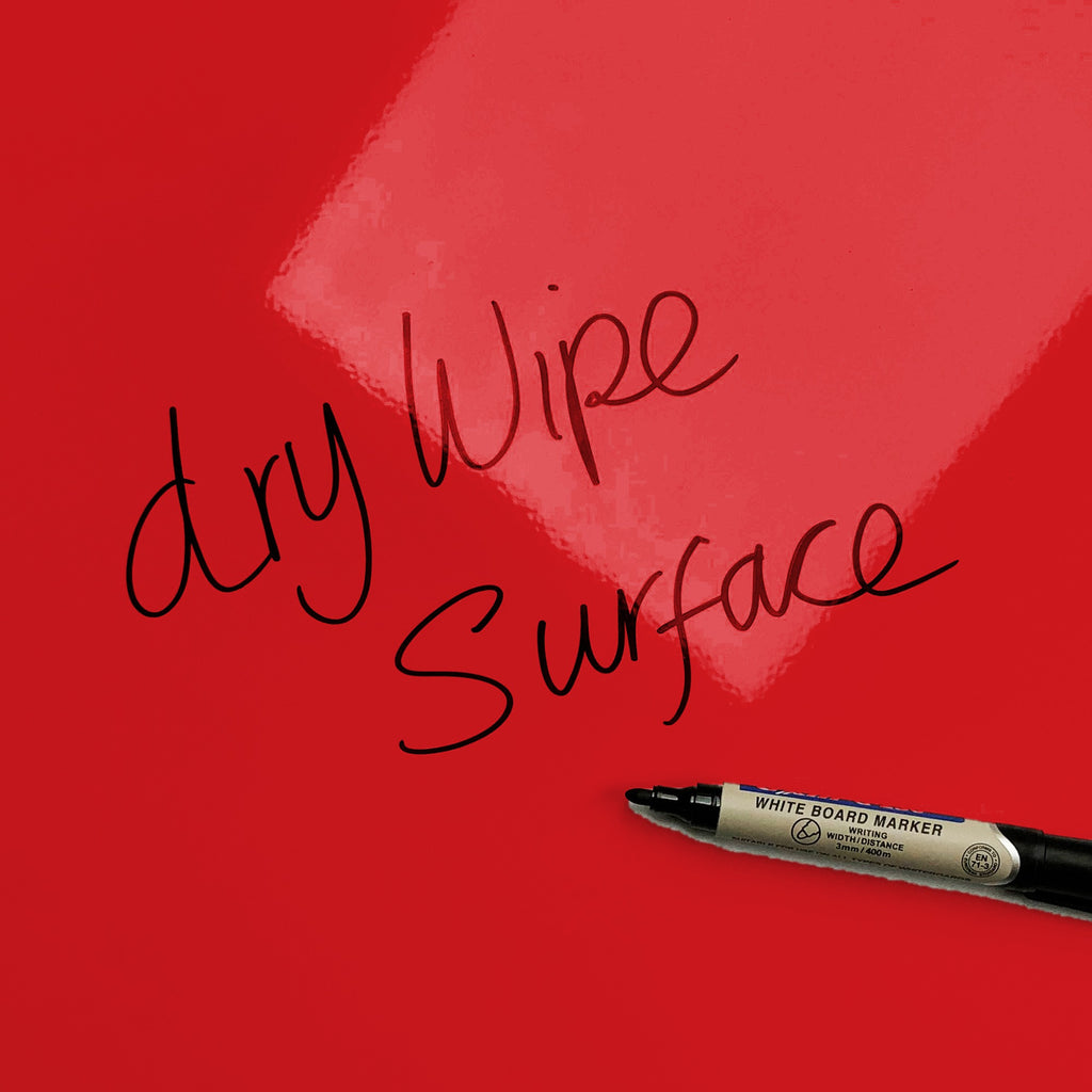 The words dry wipe surface written in marker pen on the Red Apples Apples magnetic notice board