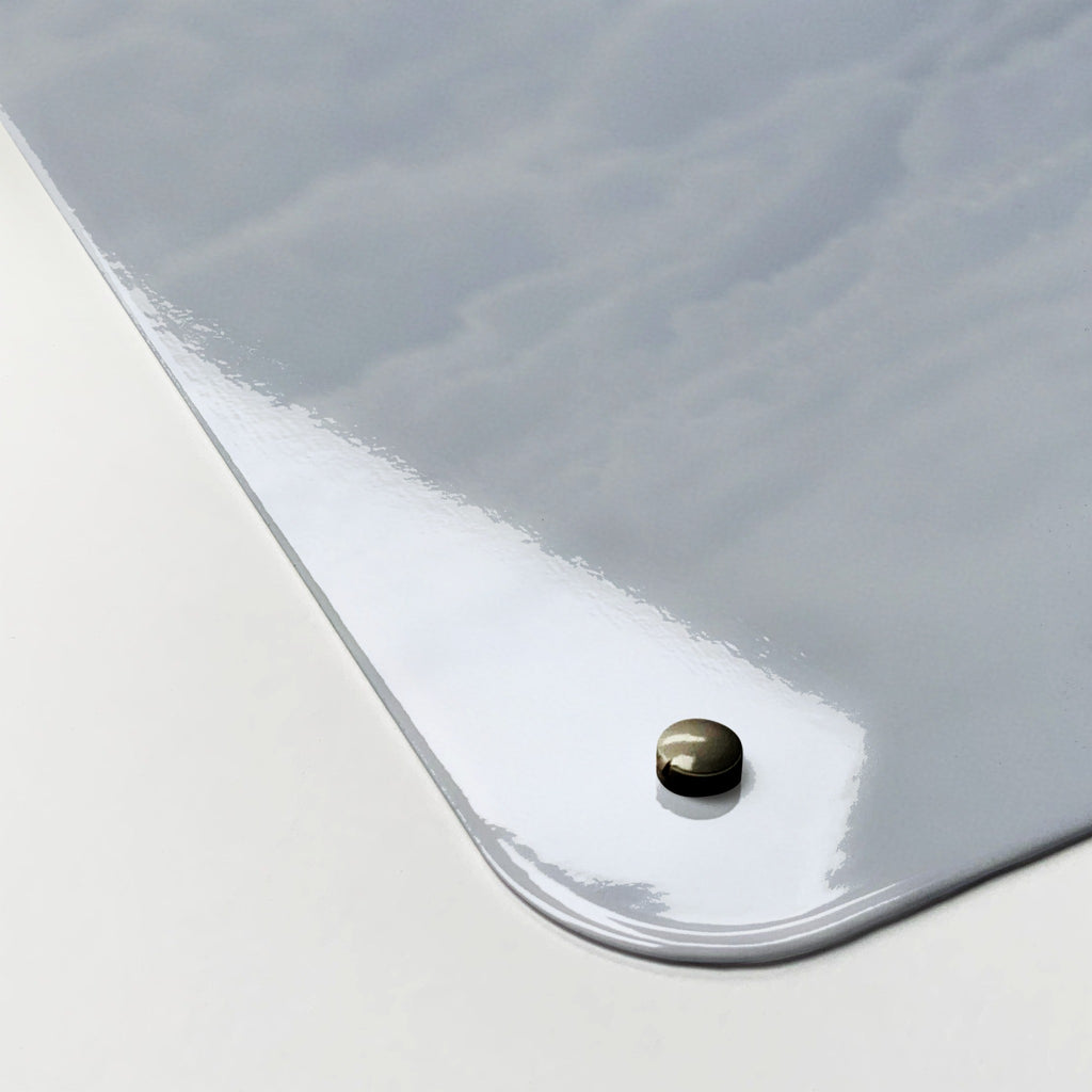 Close-up of the corner of the Artic Fox magnetic notice board, showing the gloss finish and a screw cap