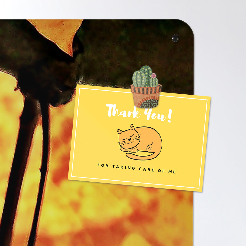 A postcard held by a fridge magnet on the Autumn Tree magnetic notice board