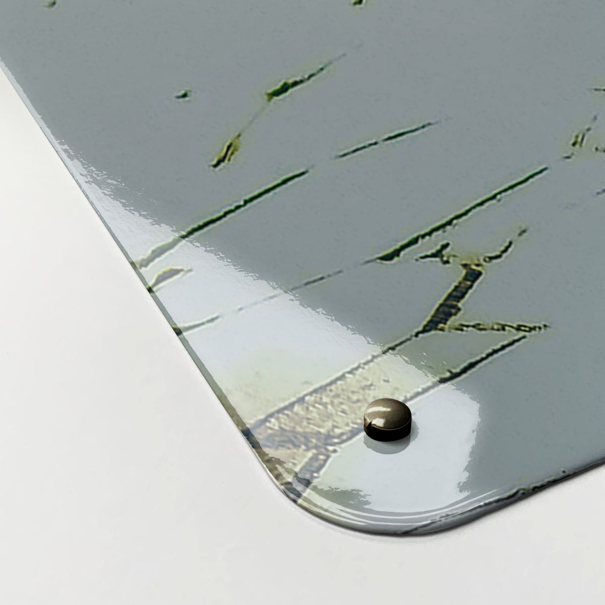 Close-up of the corner of the Bicycle And Flower Basket magnetic notice board, showing the gloss finish and a screw cap