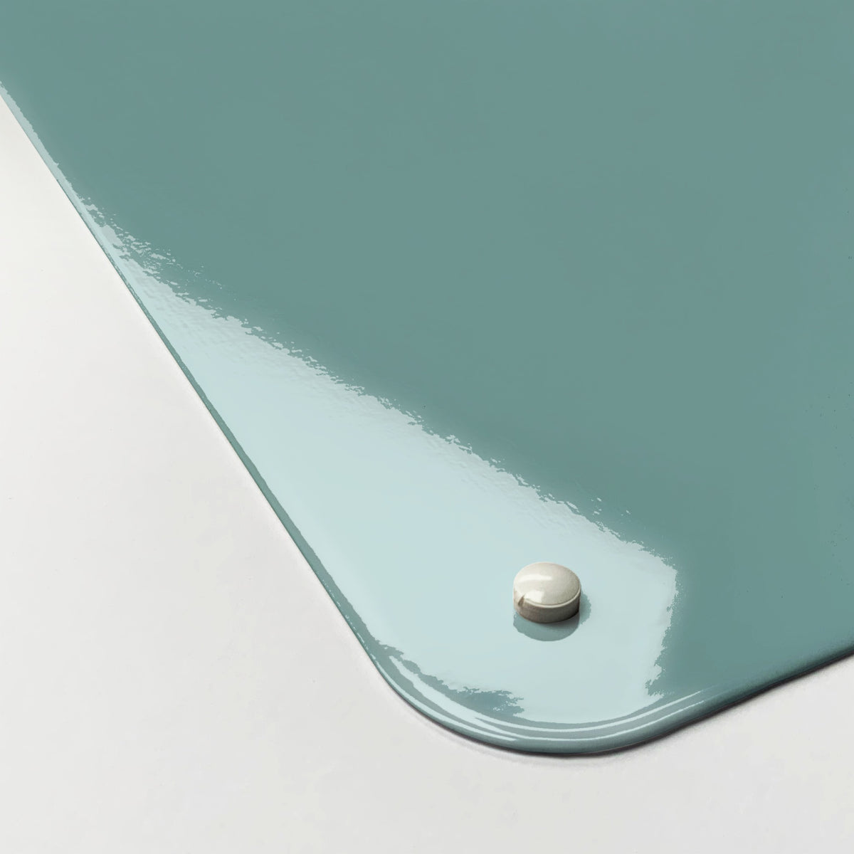 Close-up of the corner of the Birds In A Tree magnetic notice board in Coloured Birds in a Tree, showing the gloss finish and a screw cap