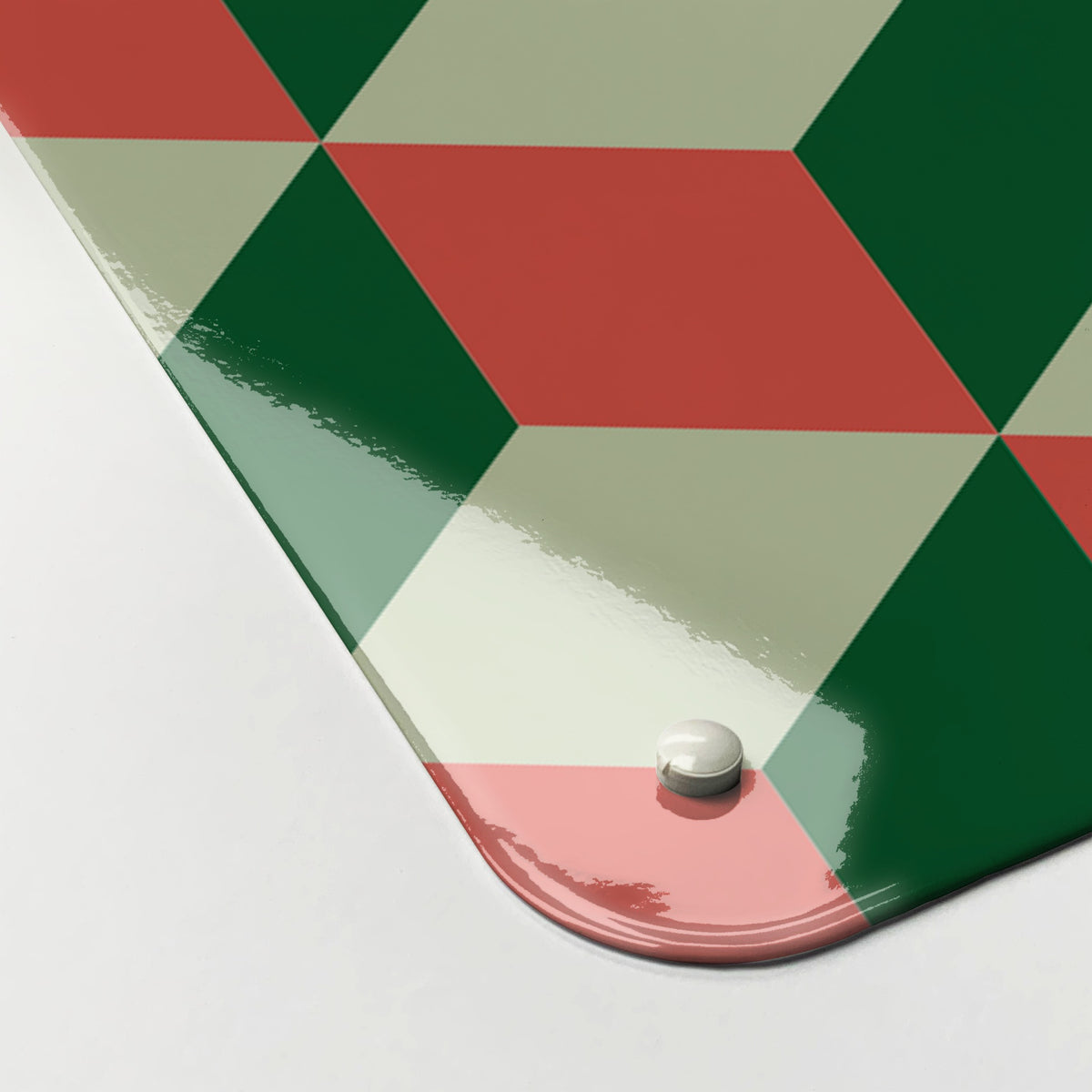 Close-up of the corner of the Blocks Design magnetic notice board in Red Cream and Green, showing the gloss finish and a screw cap