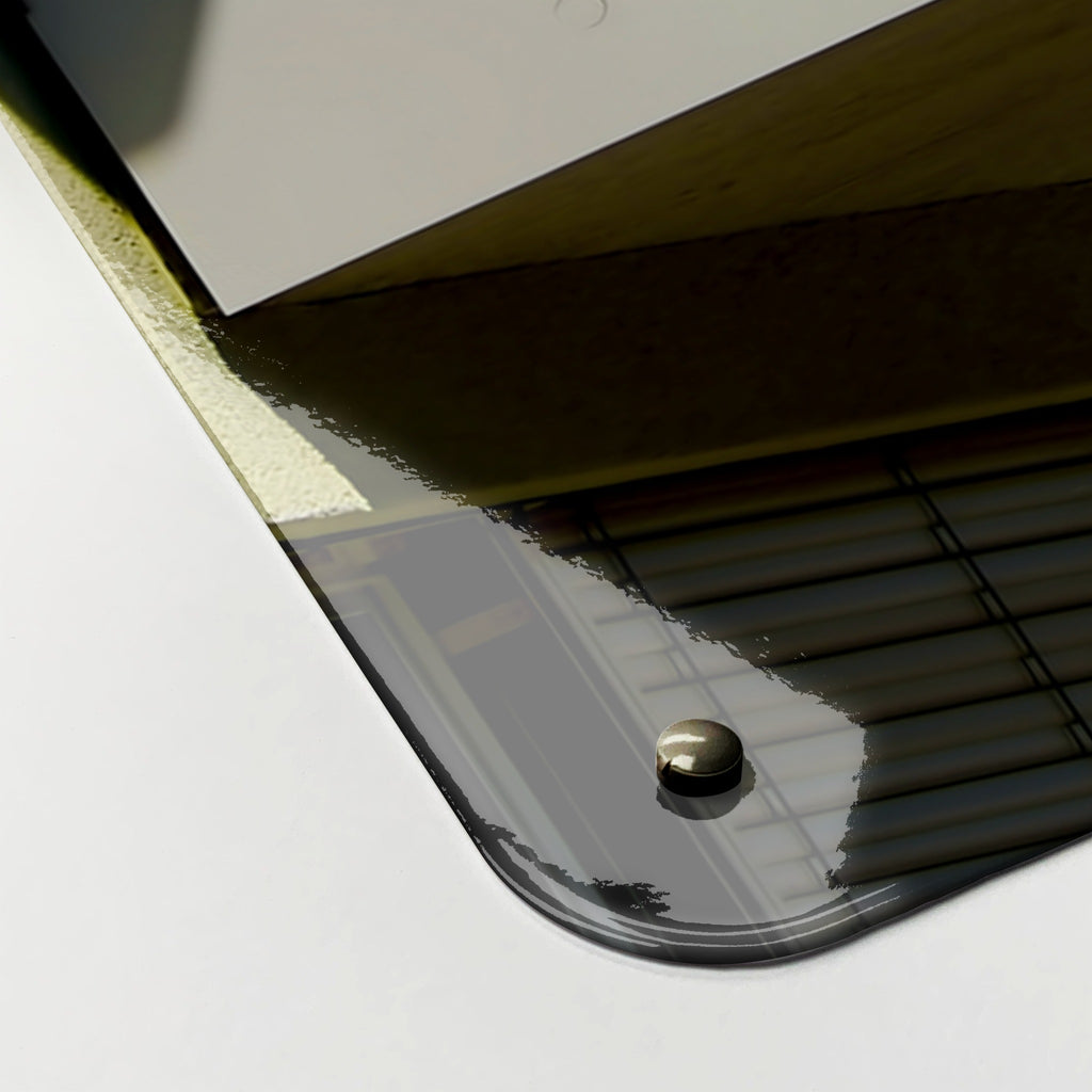 Close-up of the corner of the Brutalist Balconies magnetic notice board, showing the gloss finish and a screw cap