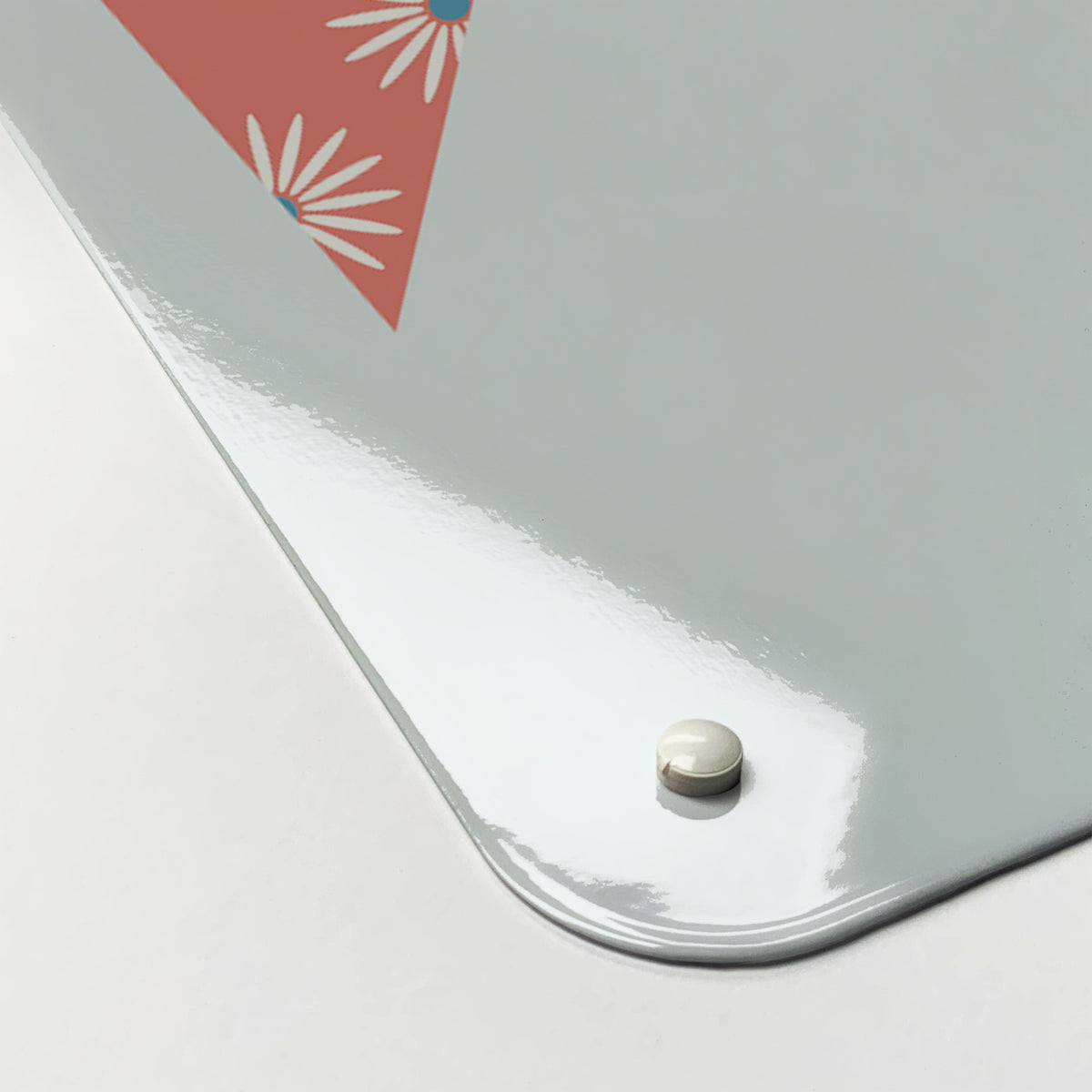 Close-up of the corner of the Bunting magnetic notice board, showing the gloss finish and a screw cap