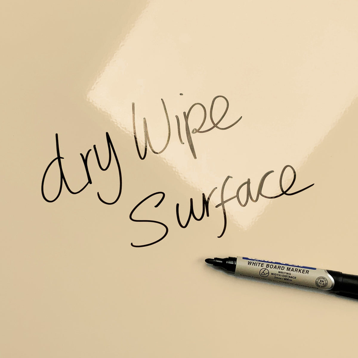 The words dry wipe surface written in marker pen on the But First Coffee Quote magnetic notice board