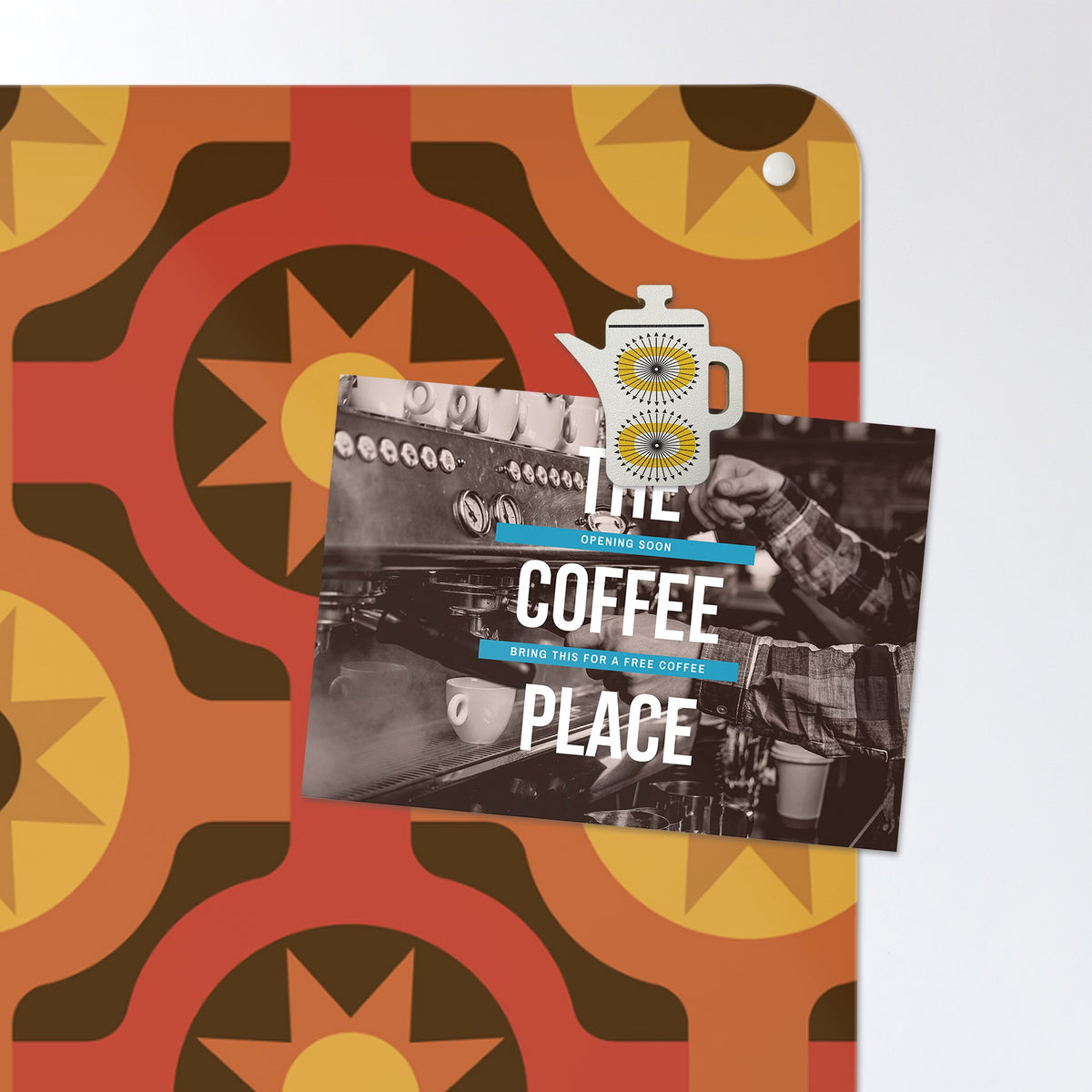 A postcard held by a fridge magnet on the But First Coffee Quote magnetic notice board