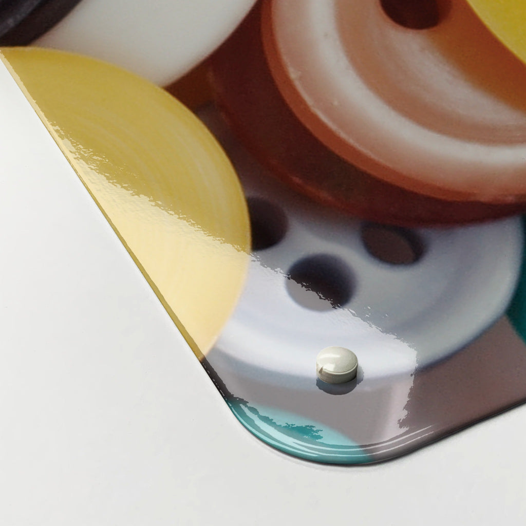 Close-up of the corner of the Buttons magnetic notice board in Buttons, showing the gloss finish and a screw cap