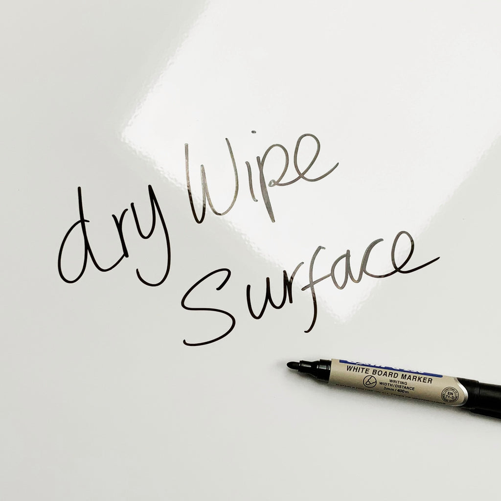 The words dry wipe surface written in marker pen on the Buttons Buttons magnetic notice board