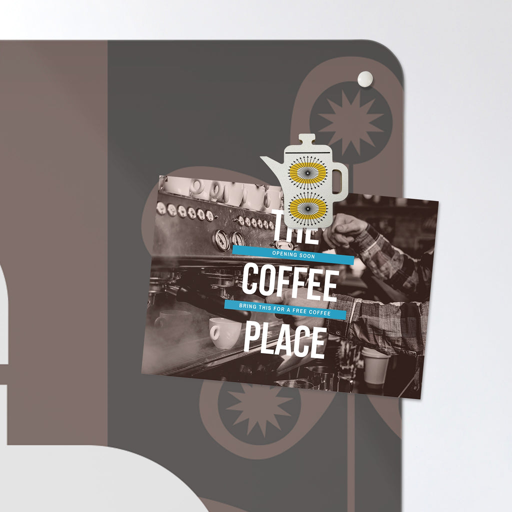 A postcard held by a fridge magnet on the Coffee Pot magnetic notice board in Coffee Pot - White