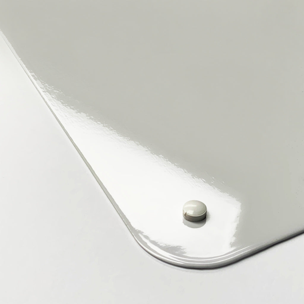 Close-up of the corner of the Coffee Quote magnetic notice board, showing the gloss finish and a screw cap