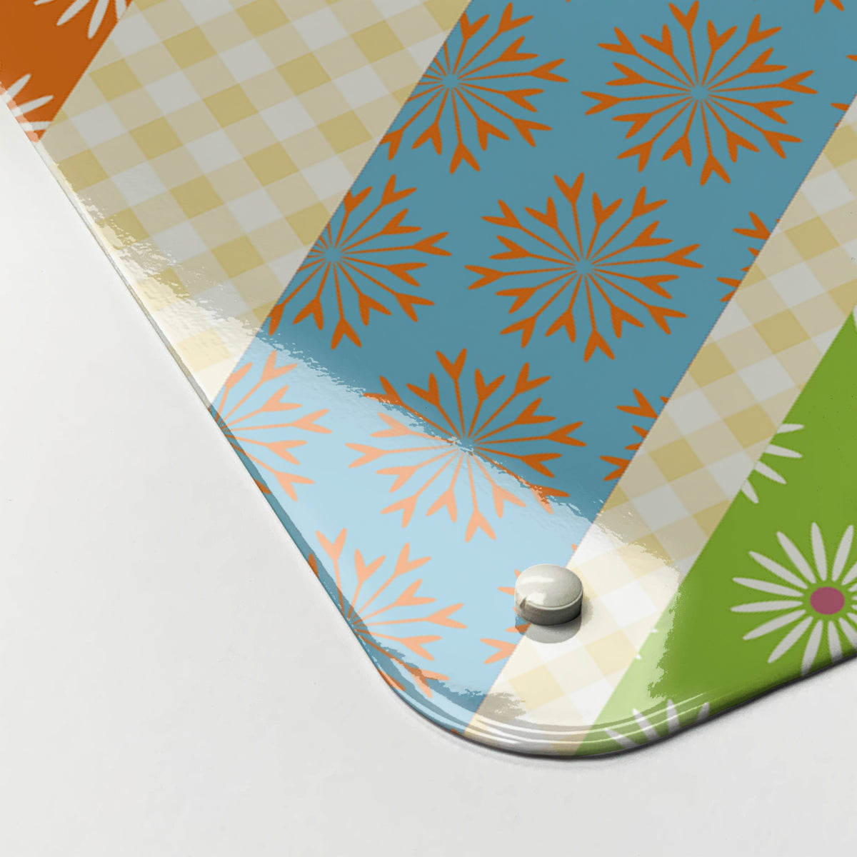 Close-up of the corner of the Cool Britannia magnetic notice board in Fruity, showing the gloss finish and a screw cap