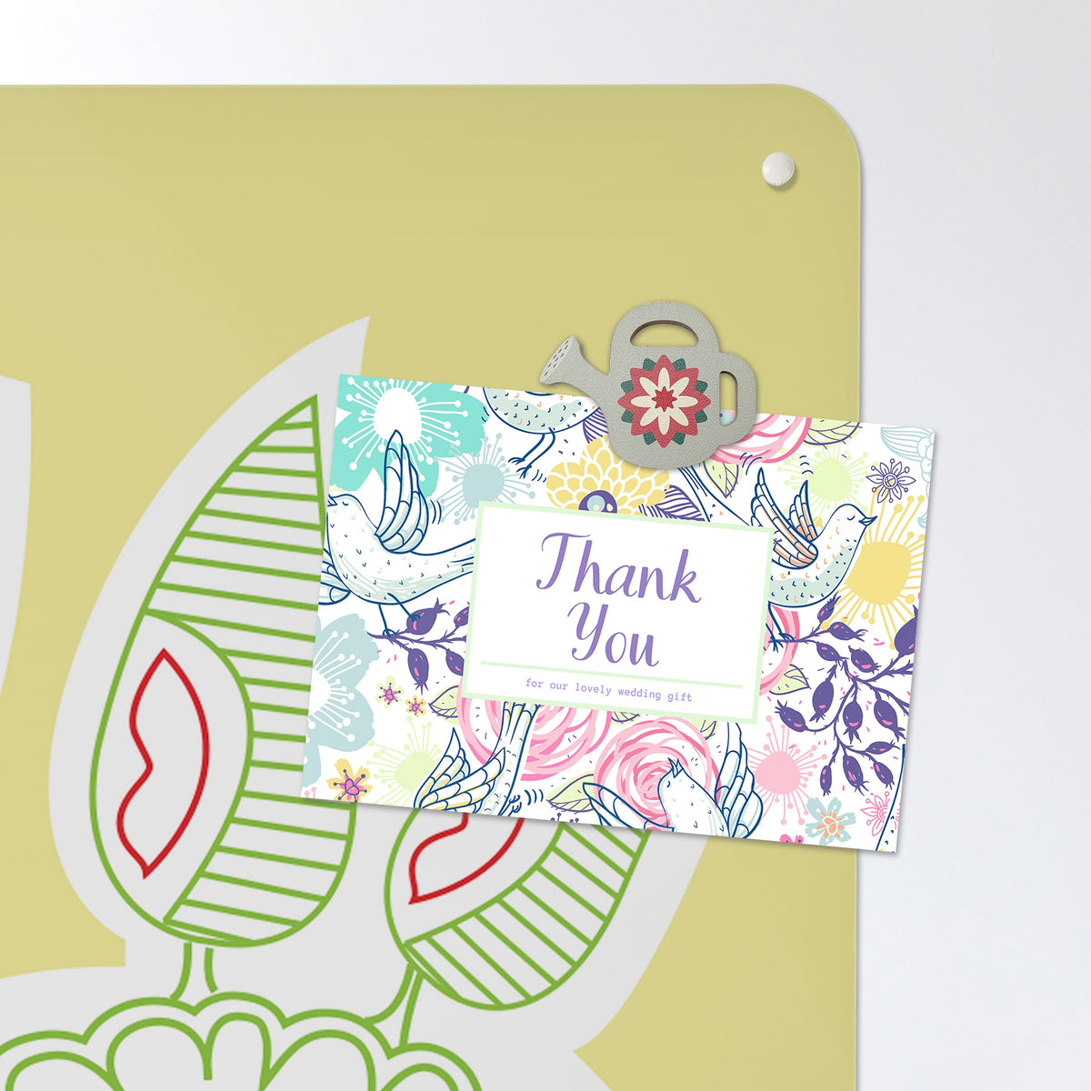 A postcard held by a fridge magnet on the Cupcake Plant magnetic notice board in Cupcake Plant - Yellow